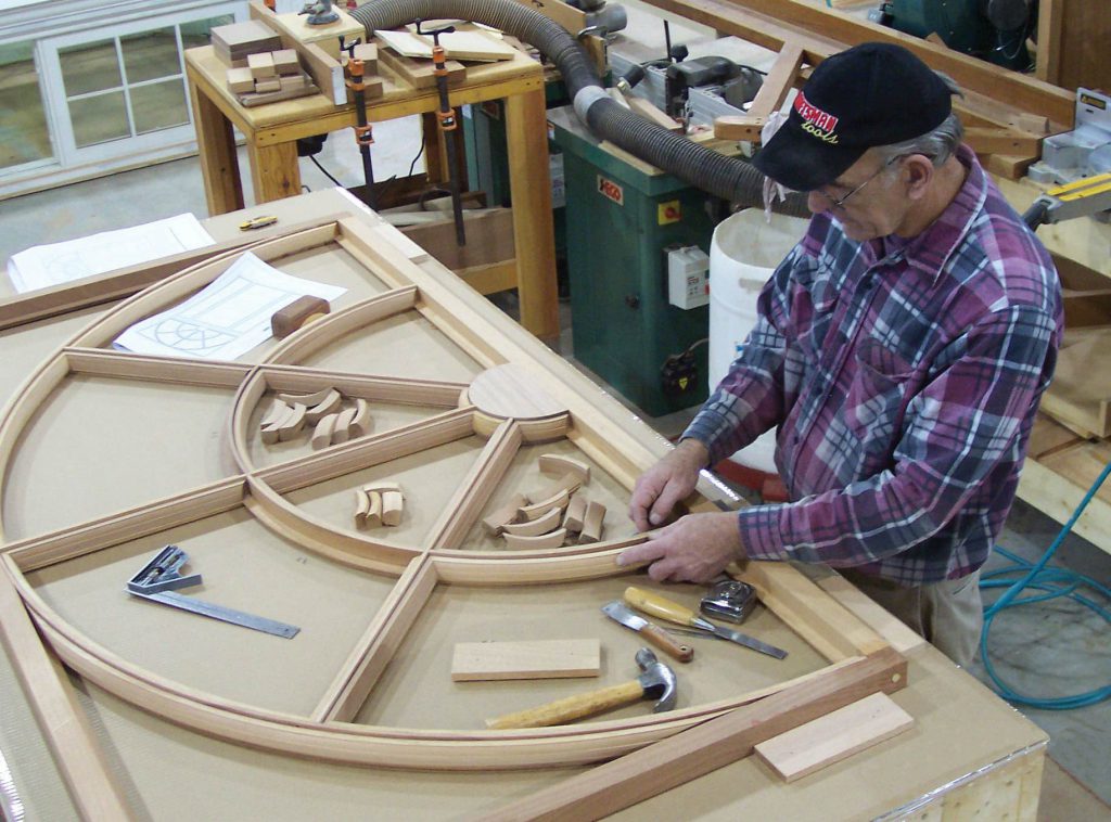 craftsman making mahogany windows and doors